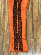 PANTALON DE CHARRO. AUTHENTIC CHARRO PANTS THAT ARE ORANGE WITH MOCA BROWN SUEDE LEATHER STITCHED STENCIL ART WORK