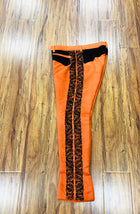 PANTALON DE CHARRO. AUTHENTIC CHARRO PANTS THAT ARE ORANGE WITH MOCA BROWN SUEDE LEATHER STITCHED STENCIL ART WORK